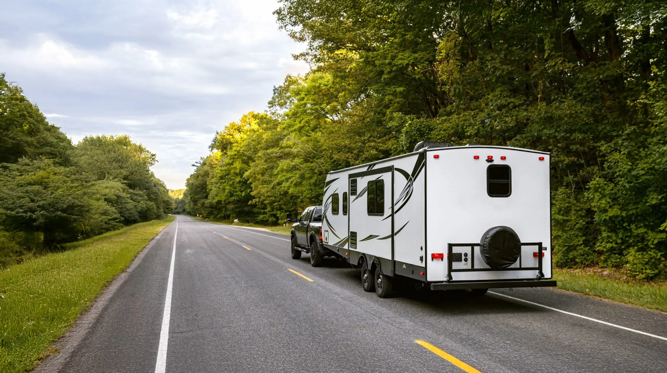 Class C motorhome and towable travel caravan on an outback highway